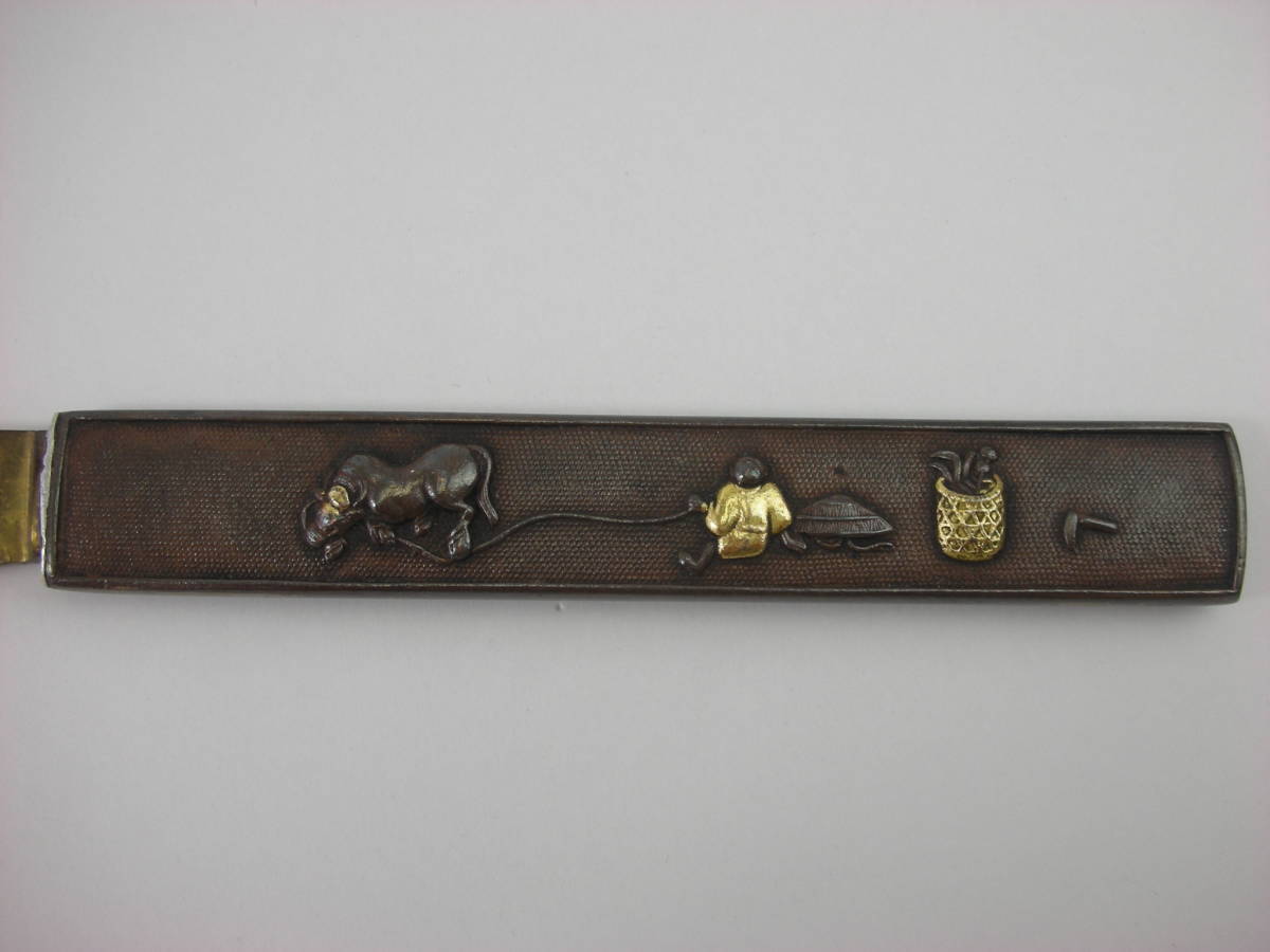 Kozuka Figure of a person pulling an old cow Petite Japan Antiques