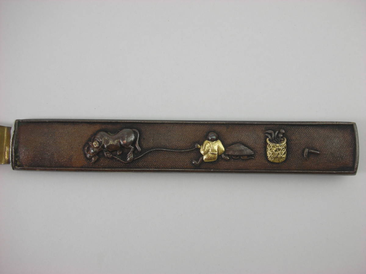 Kozuka Figure of a person pulling an old cow Petite Japan Antiques