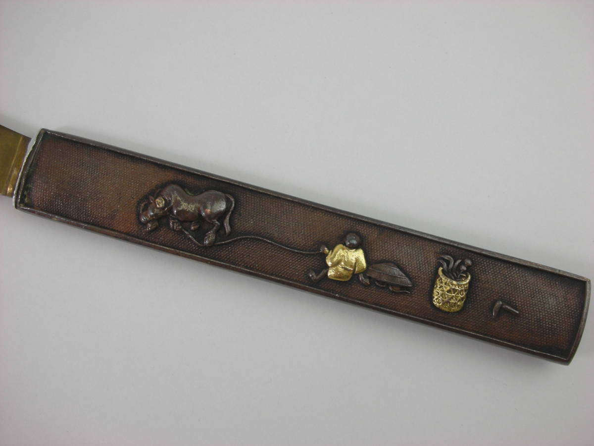 Kozuka Figure of a person pulling an old cow Petite Japan Antiques