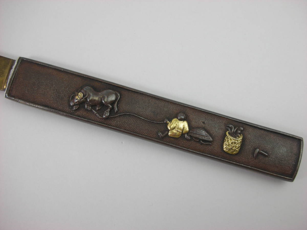 Kozuka Figure of a person pulling an old cow Petite Japan Antiques